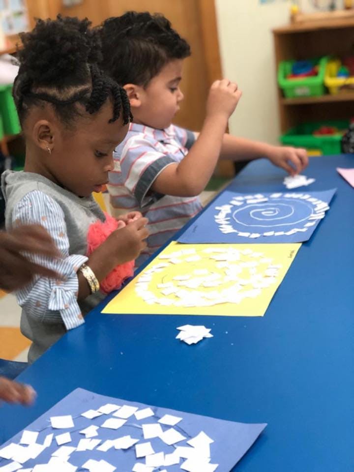 Two children doing crafts at a table