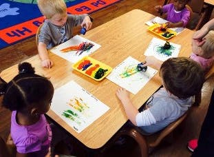Children painting at a table