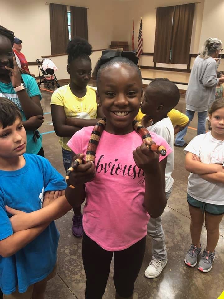 Child holding a toy snake