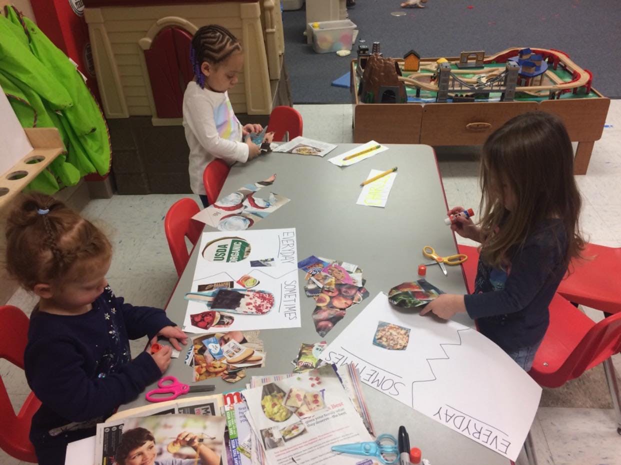 Three children doing crafts at a table
