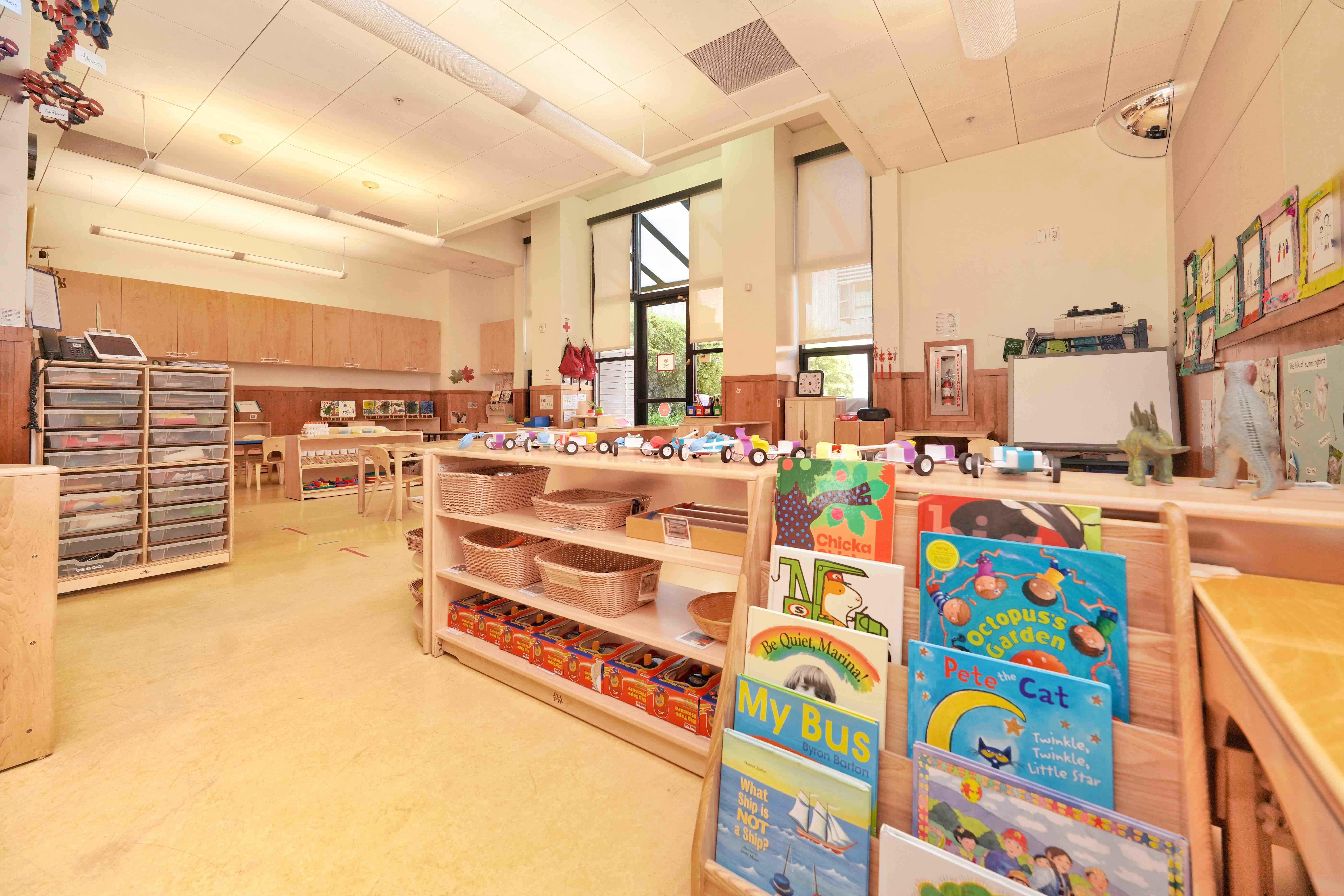 Classroom interior with bookshelves and children's books on display