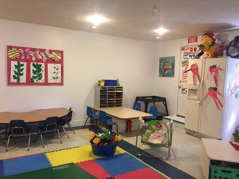 Classroom with tables, chairs, and colorful floor mats