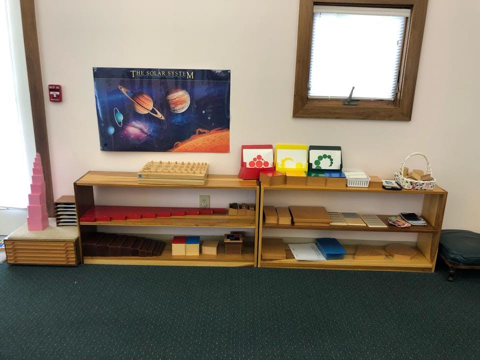 Montessori classroom with wooden shelves and learning materials