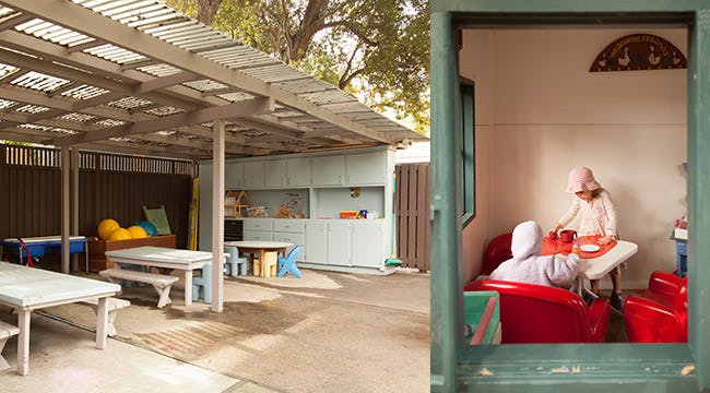 Outdoor patio with picnic tables and a play kitchen, with a child playing inside