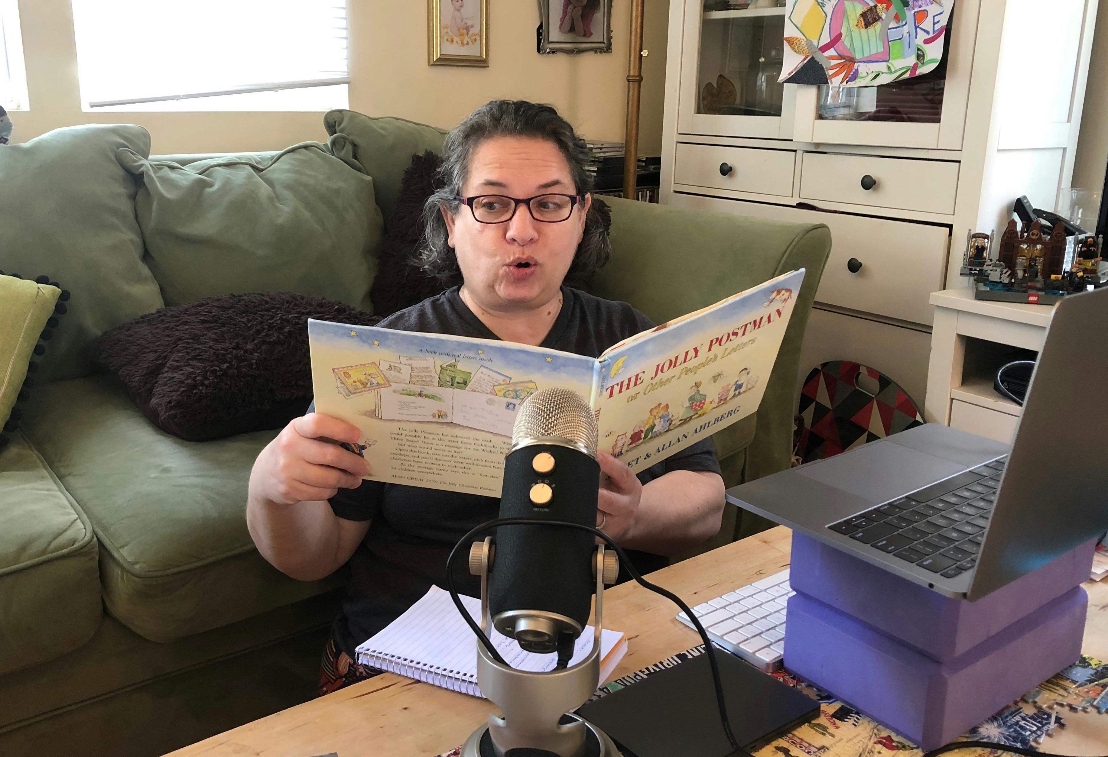 Person reading a book into a microphone