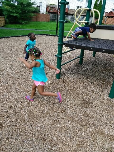 Three children playing on a playground