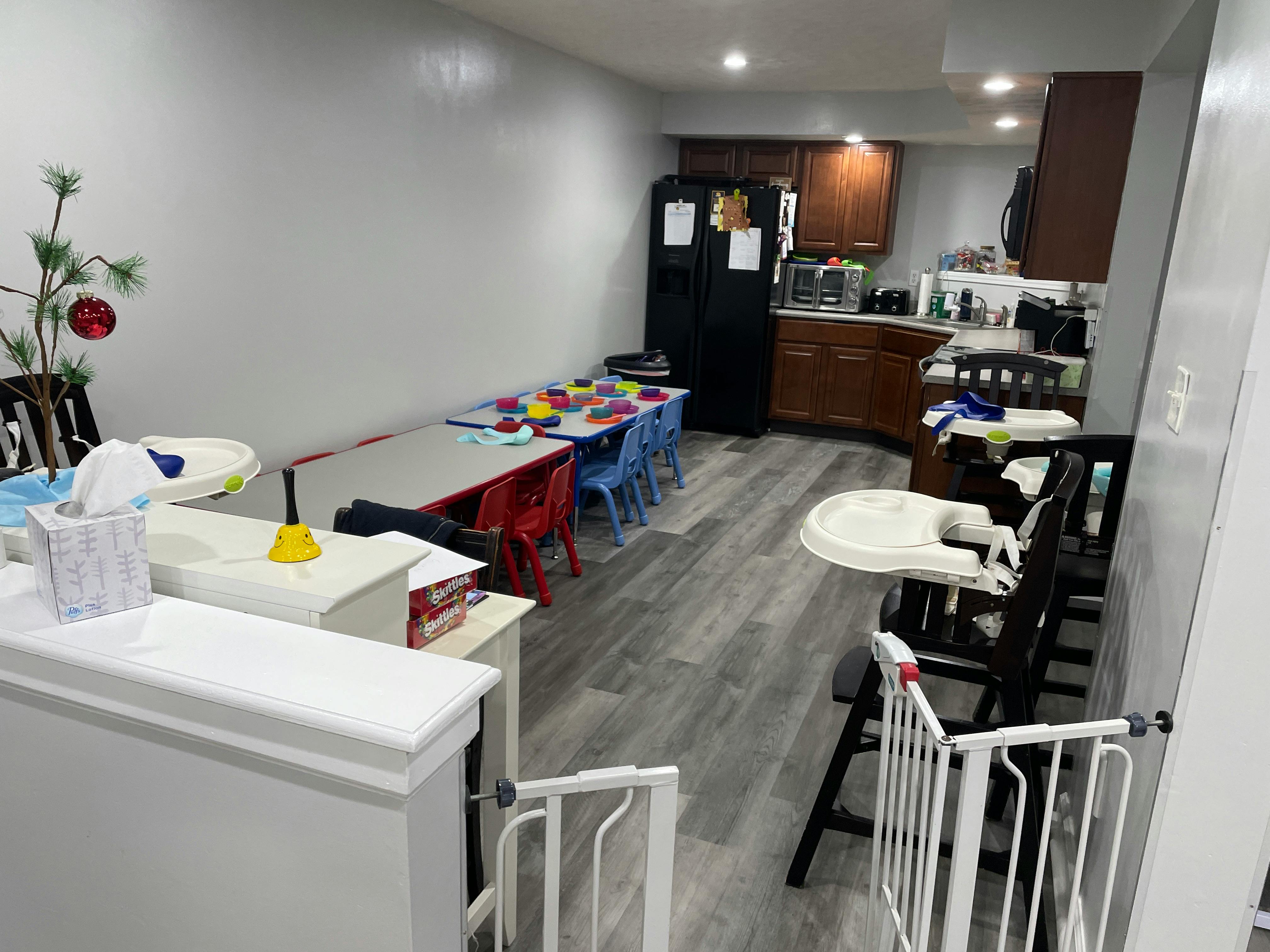 Kitchen and dining area with children's tables and high chairs