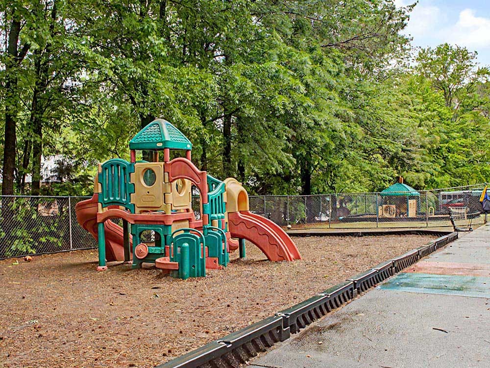 Colorful playground structure with slides on a wood chip ground