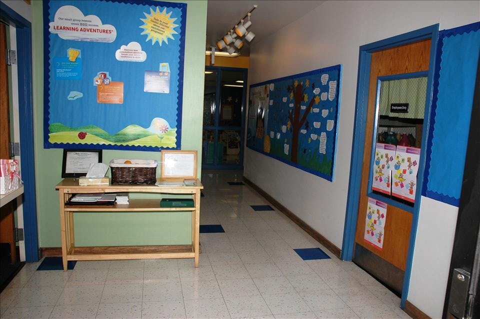Hallway decorated with children's artwork and bulletin boards