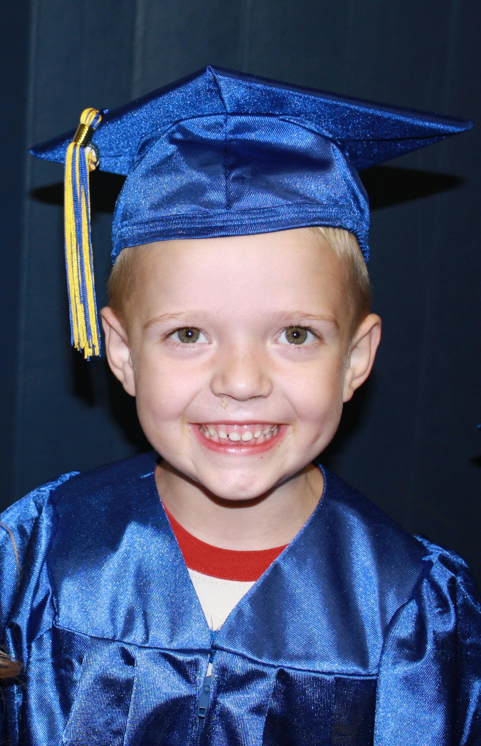 Child in blue graduation cap and gown