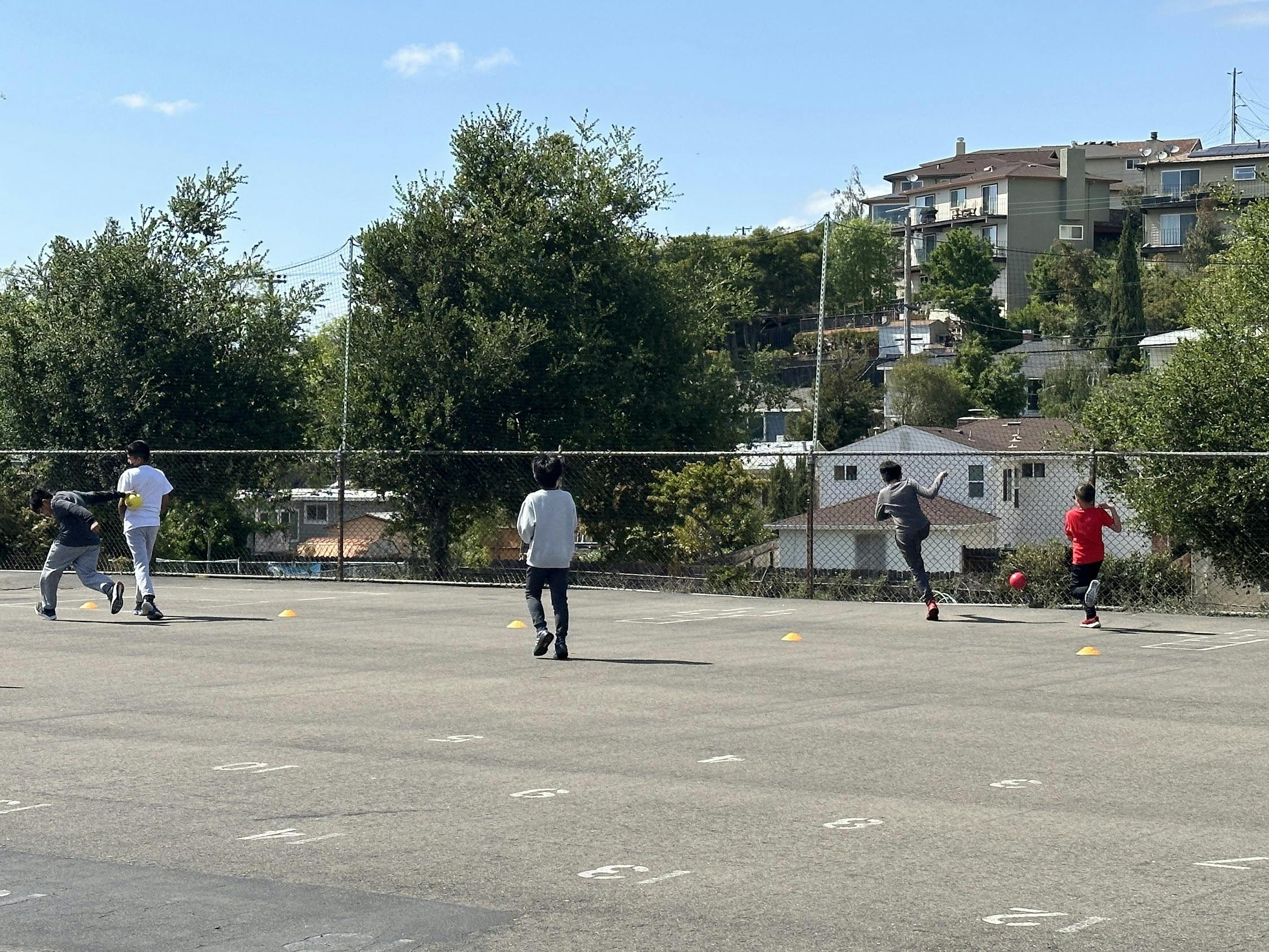 People playing soccer on an outdoor court