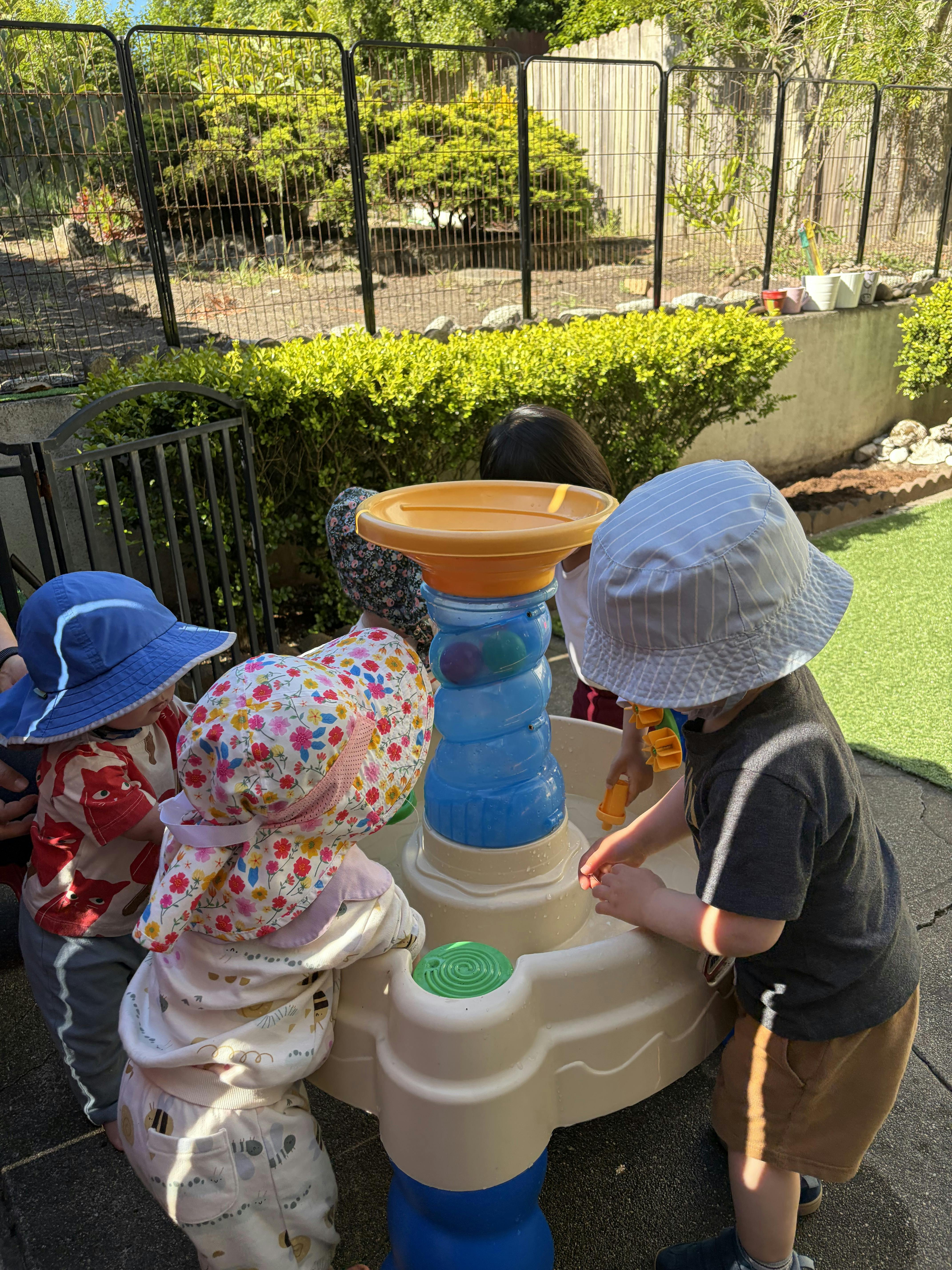 Children playing with a water table outdoors