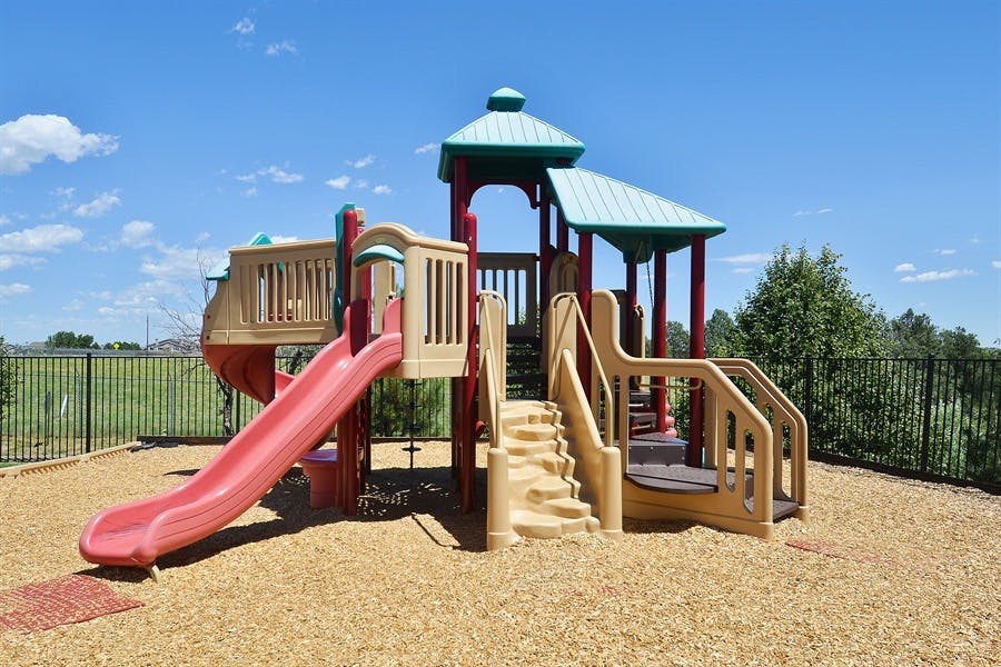 Playground structure with slides and stairs on wood chips