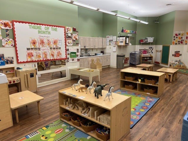 Classroom with child-sized furniture and colorful decorations on the walls