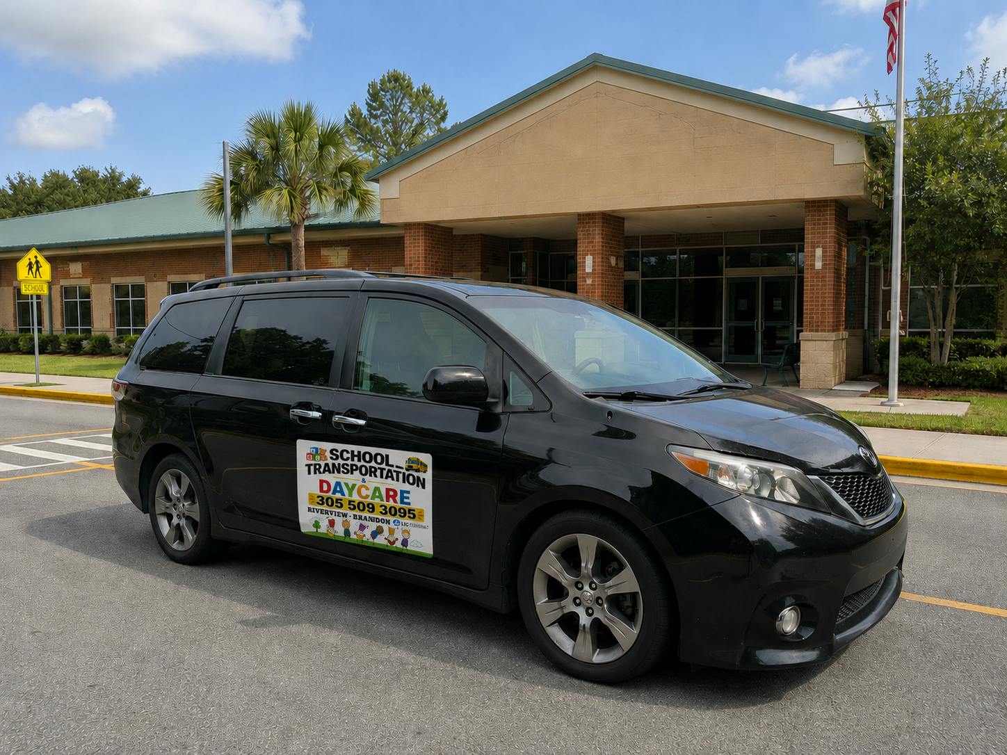 Black minivan with daycare transportation signage parked in front of a school