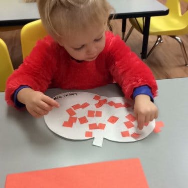 Child doing an art project at a table