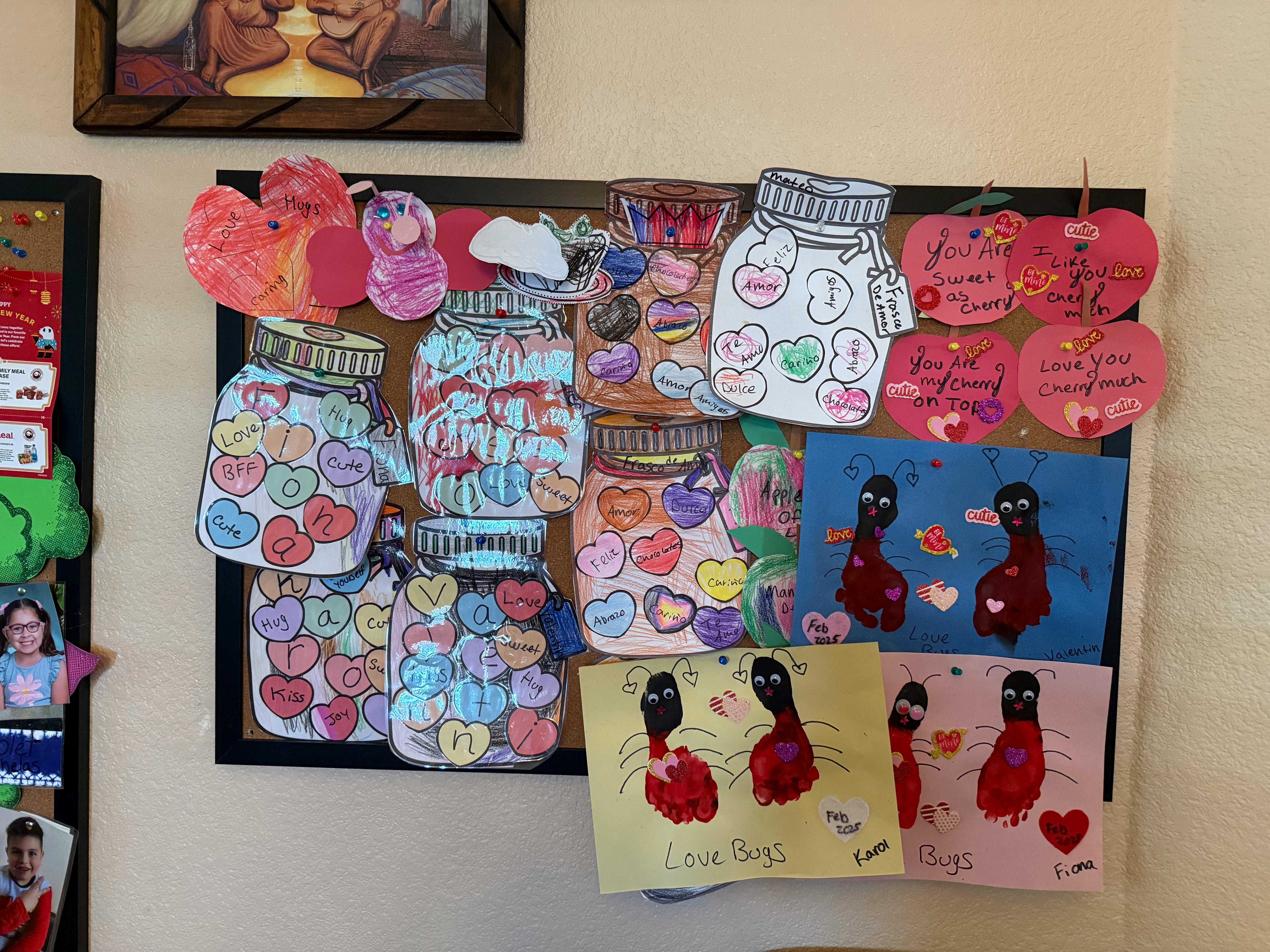 Bulletin board with paper cutouts of jars filled with hearts and abstract art