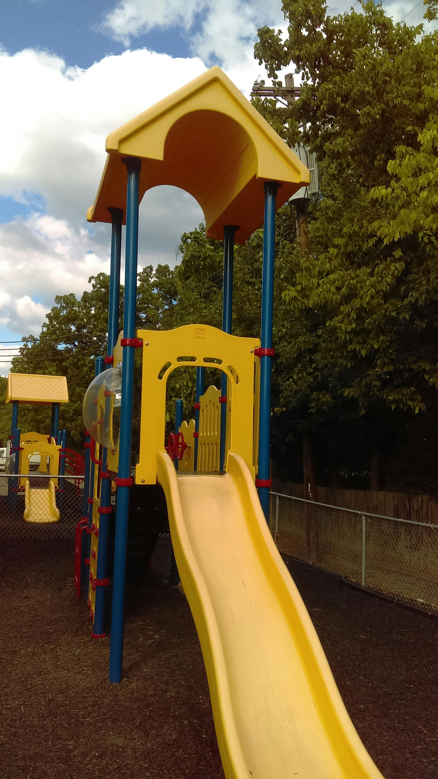Yellow playground slide and structure