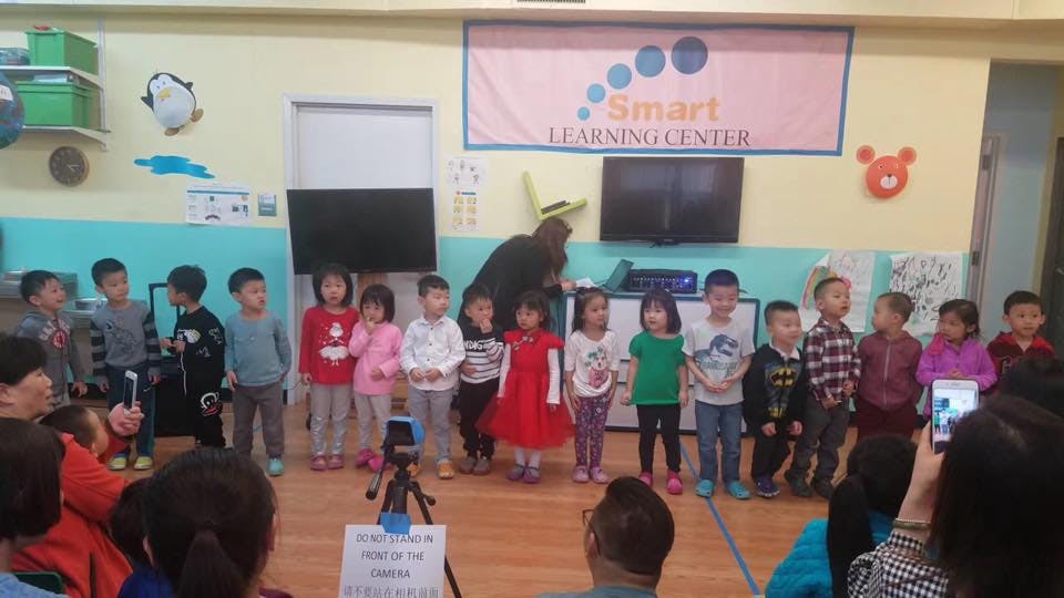Group of children standing in a line in a classroom