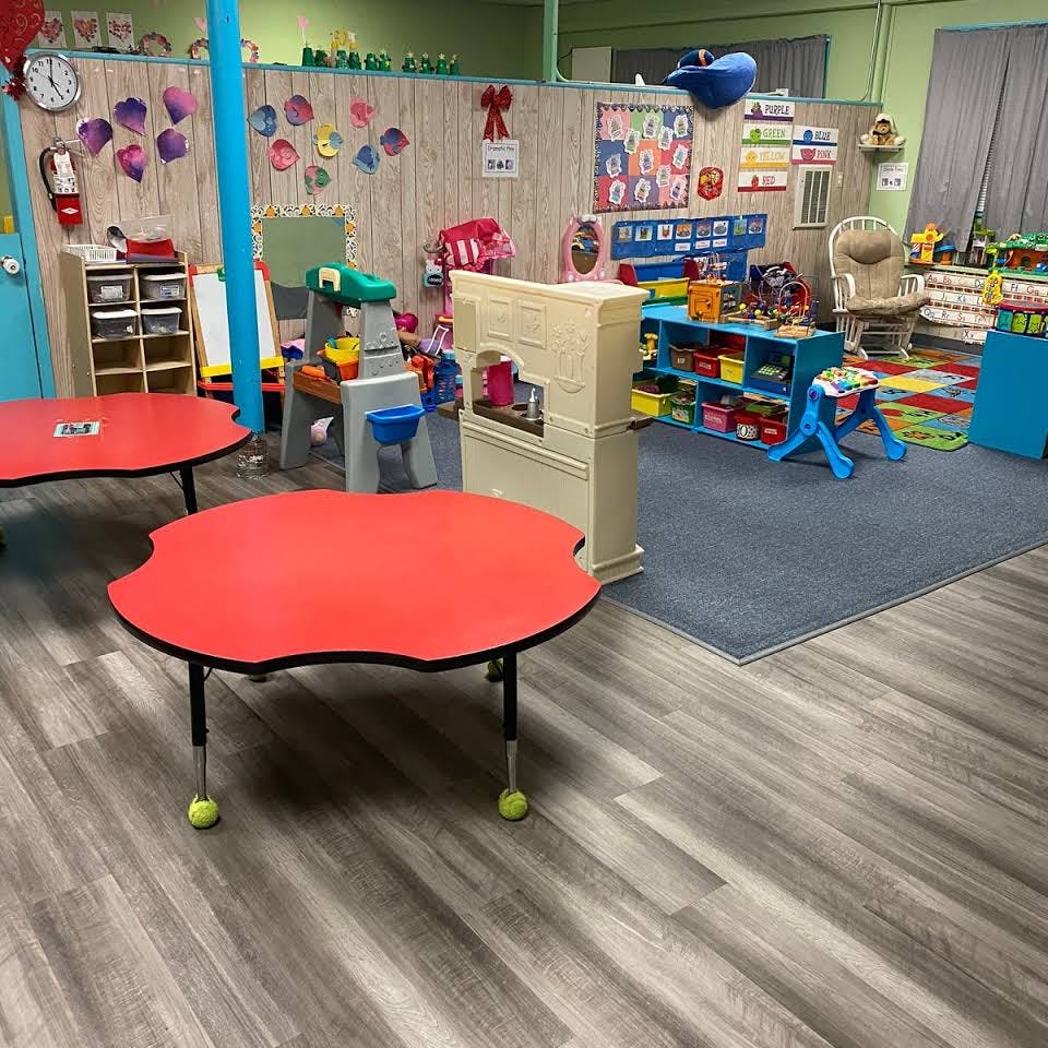 Classroom with red tables and play area