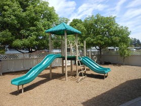 Playground with two slides and a climbing structure