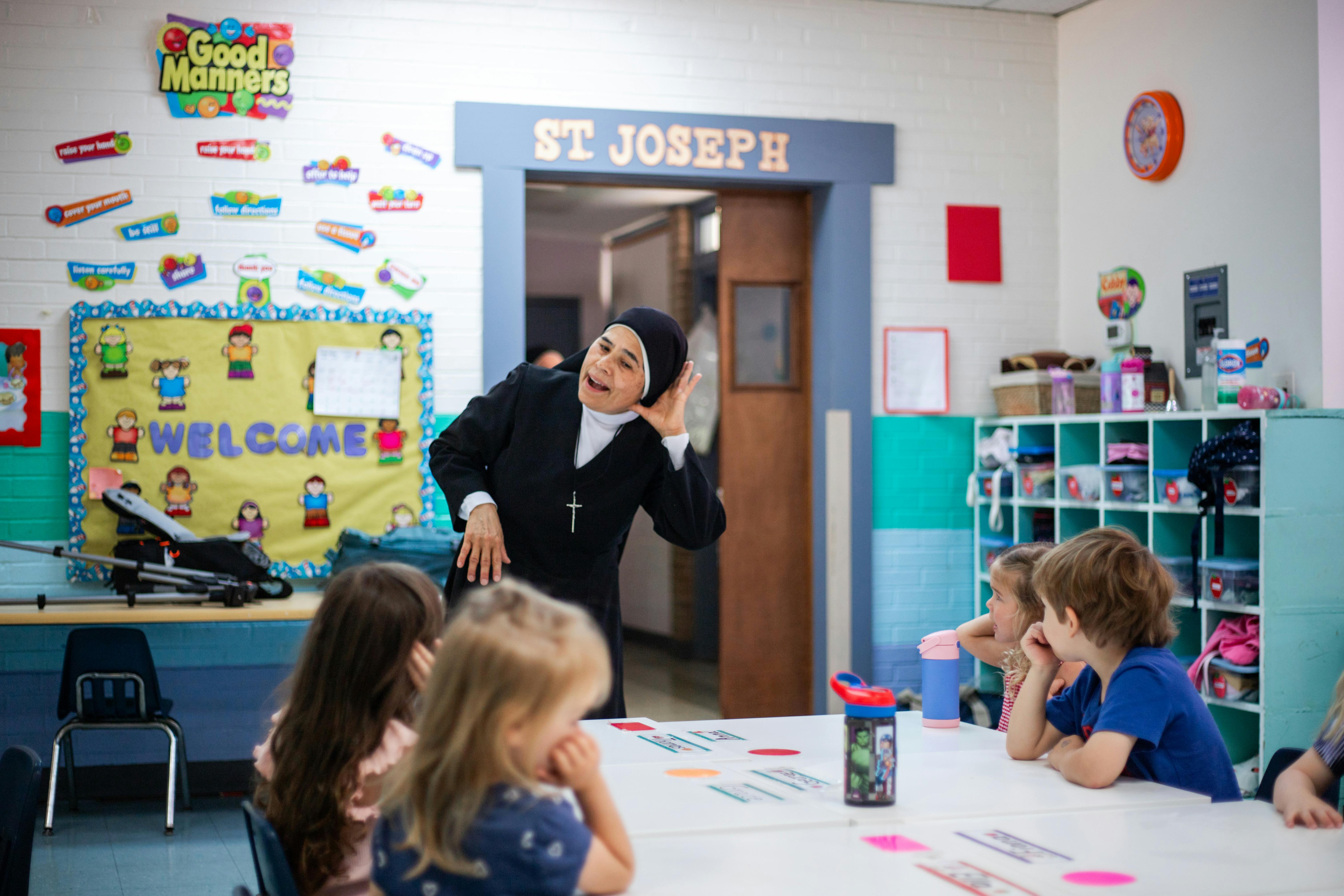 Adult speaking to children in a classroom