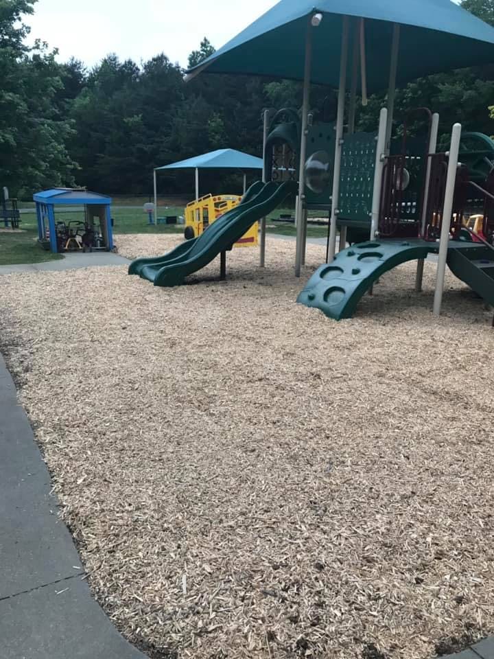 Playground with slides and climbing structures on wood chips