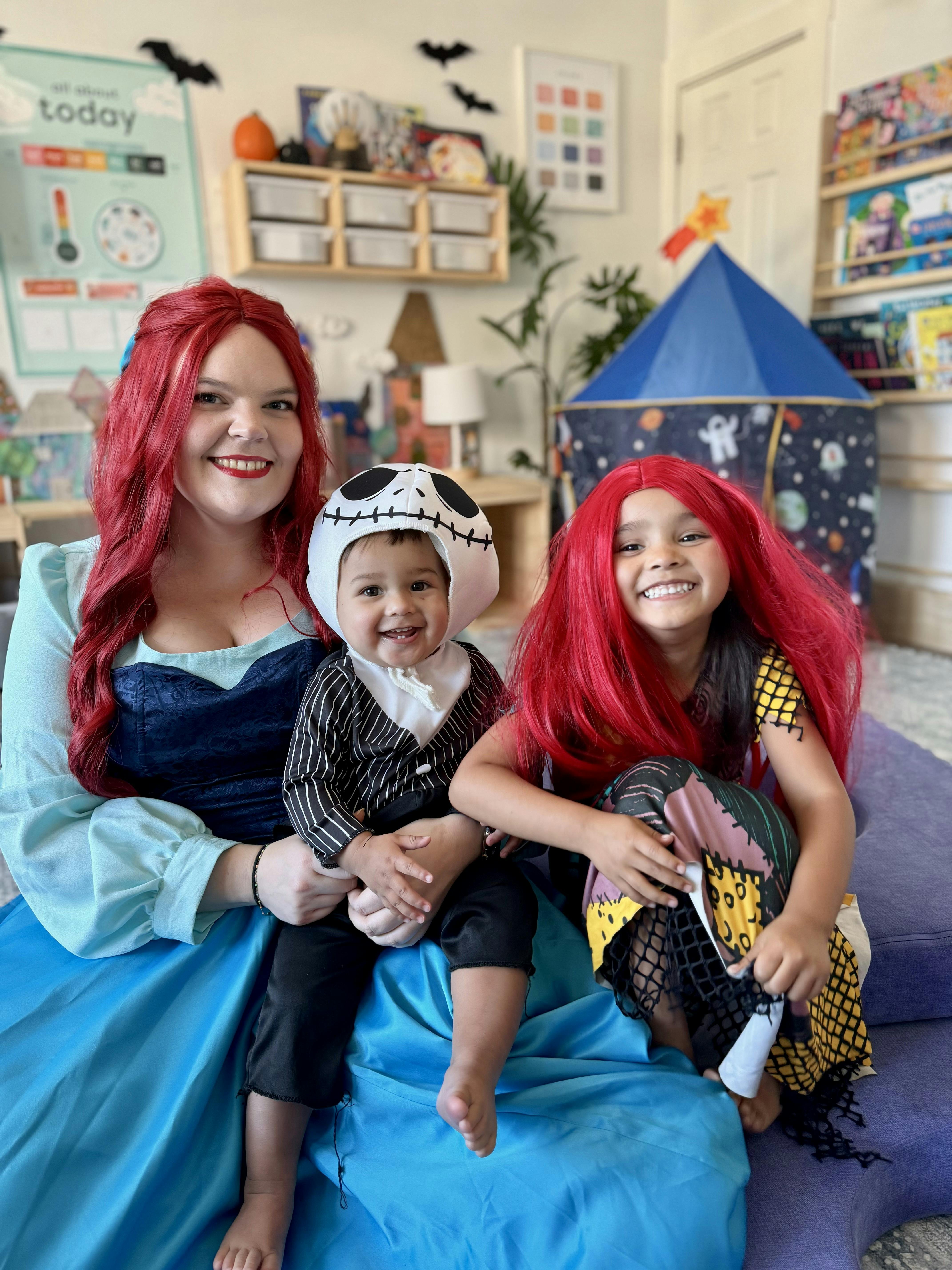Person with two children in costumes