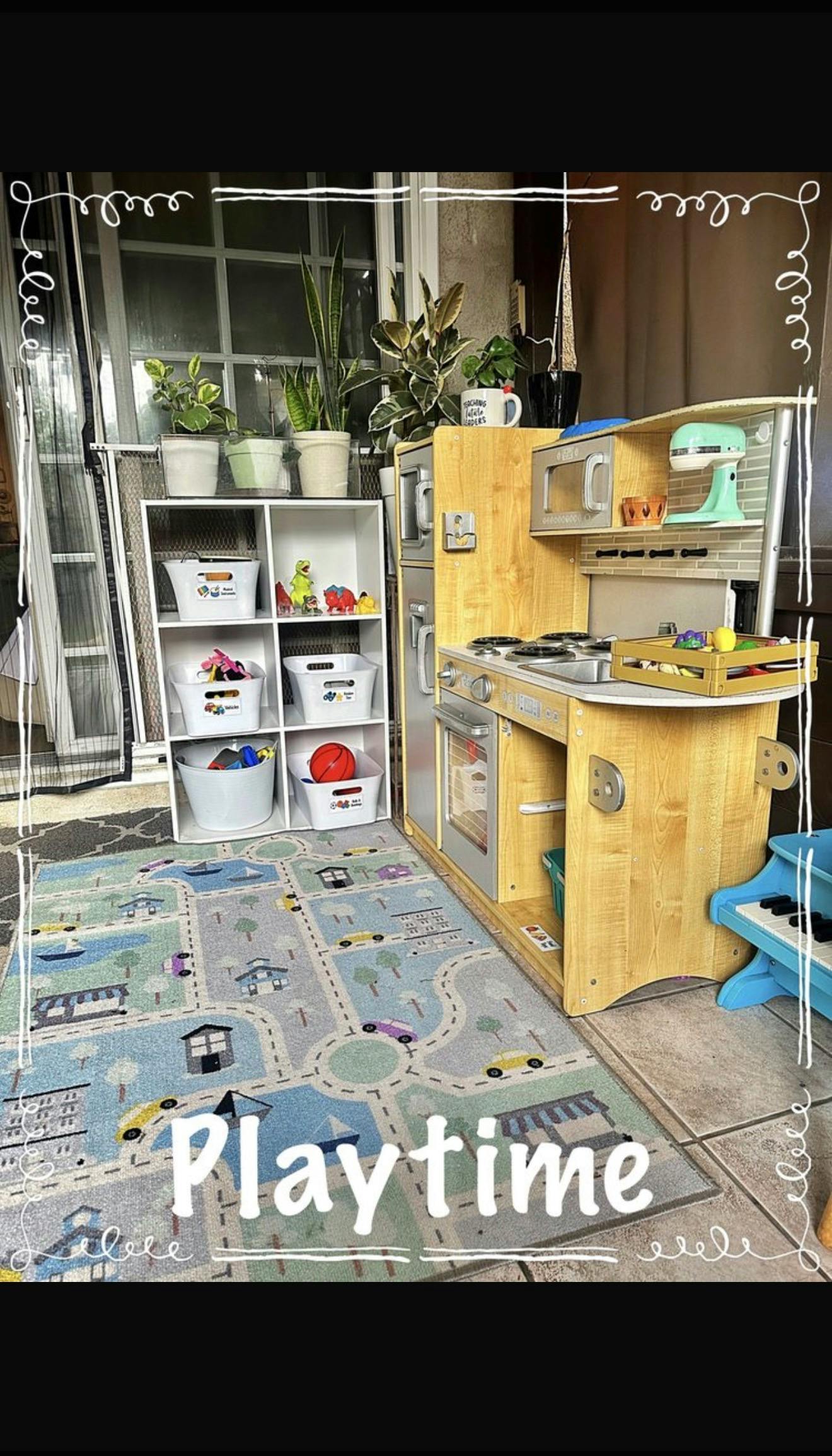 Toy kitchen set and storage shelf on a play mat