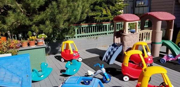 Outdoor play area with various colorful toys and play structures