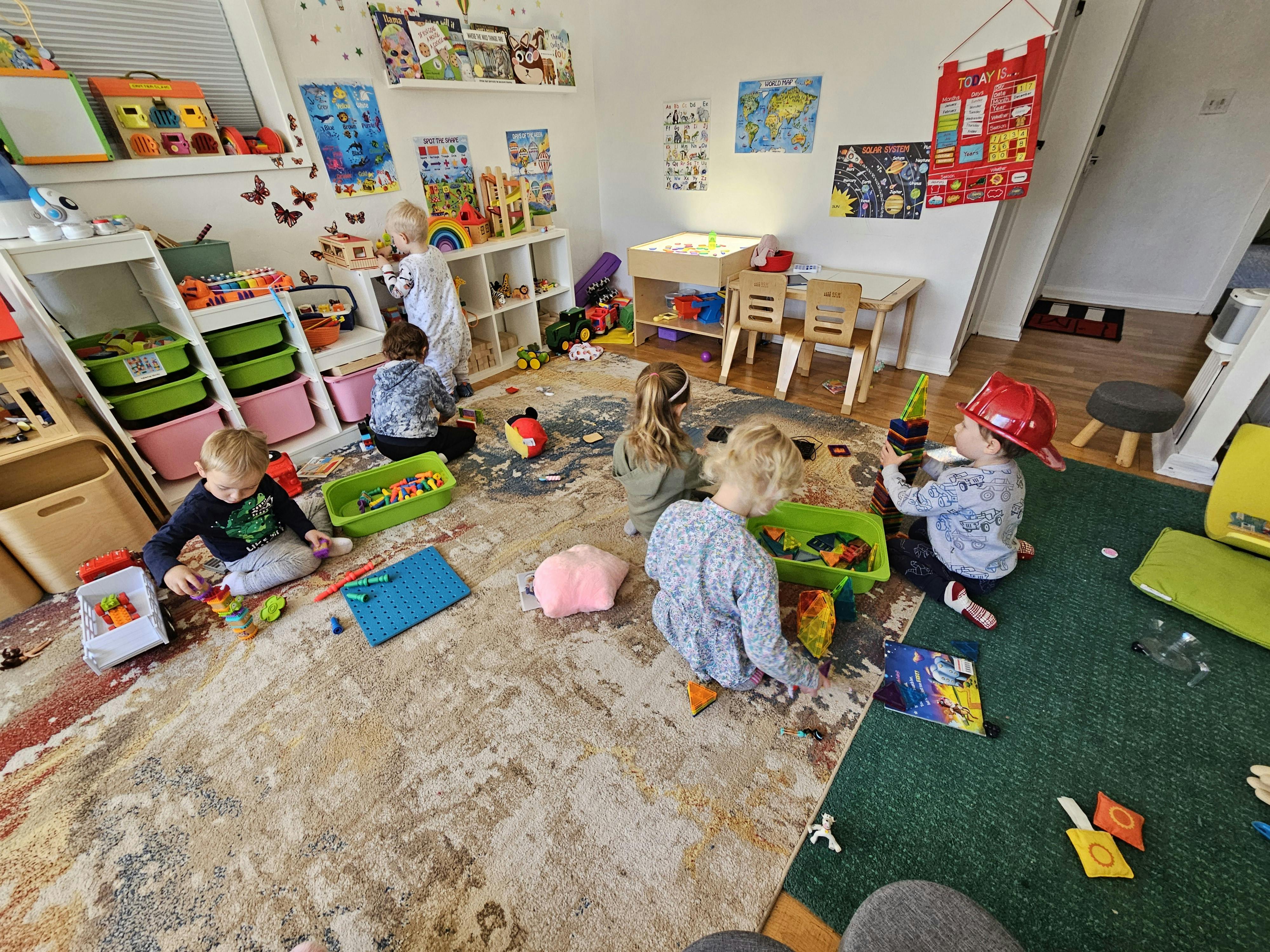 Children playing with toys on the floor in a room