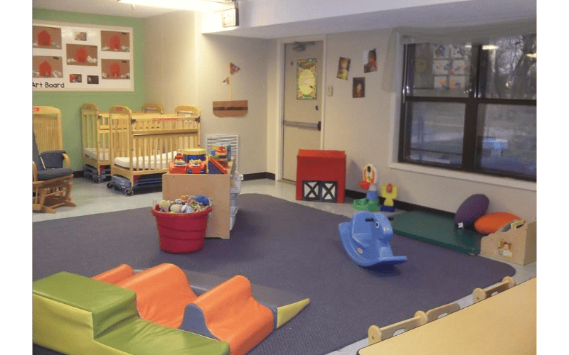 cribs and play equipment in a daycare