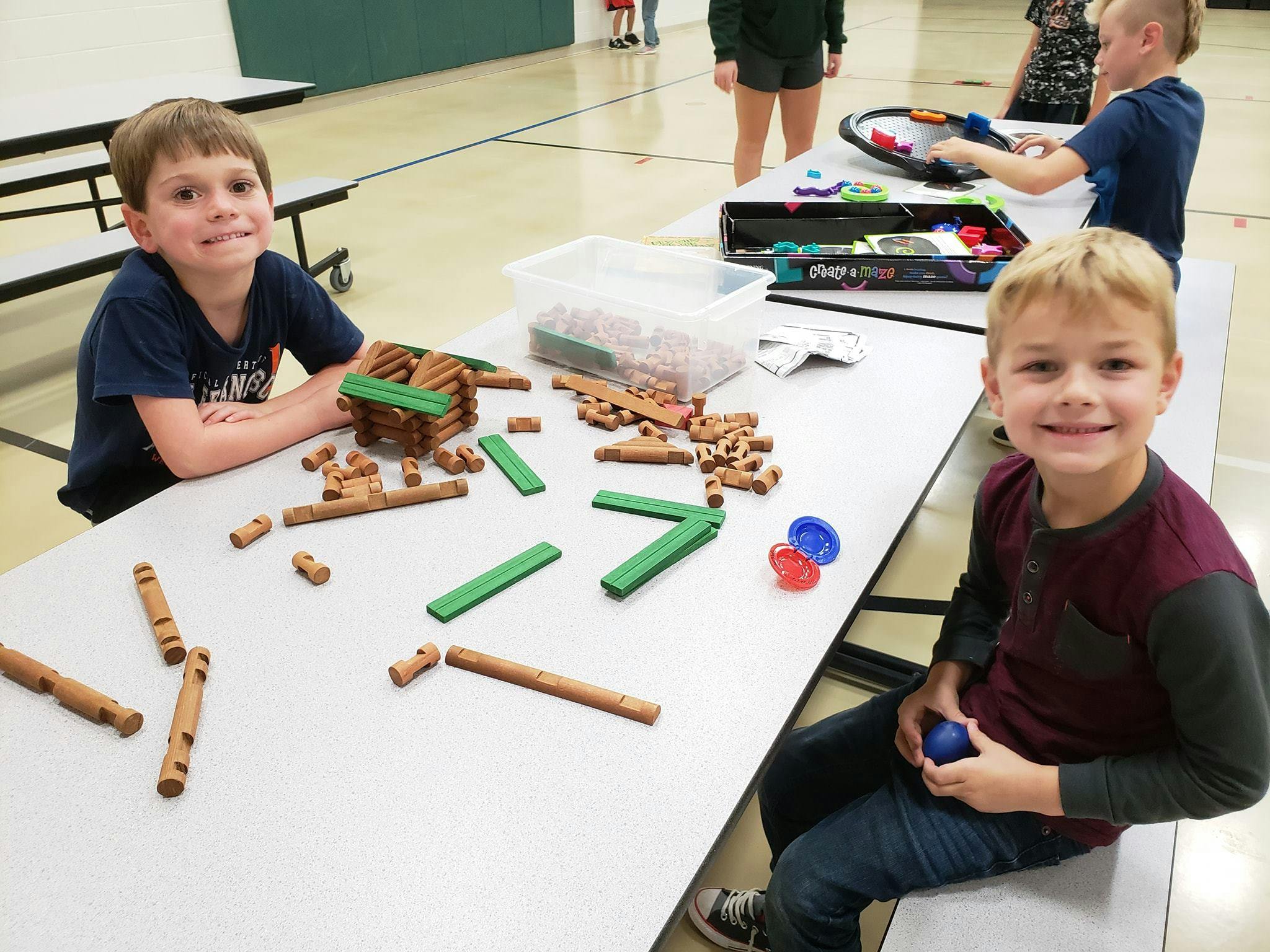 Two children at a table with building blocks