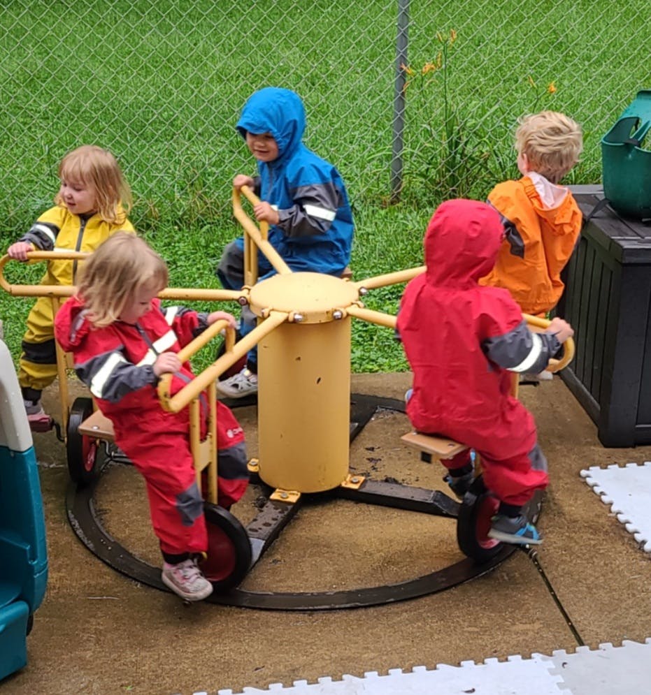 Children playing on a merry-go-round