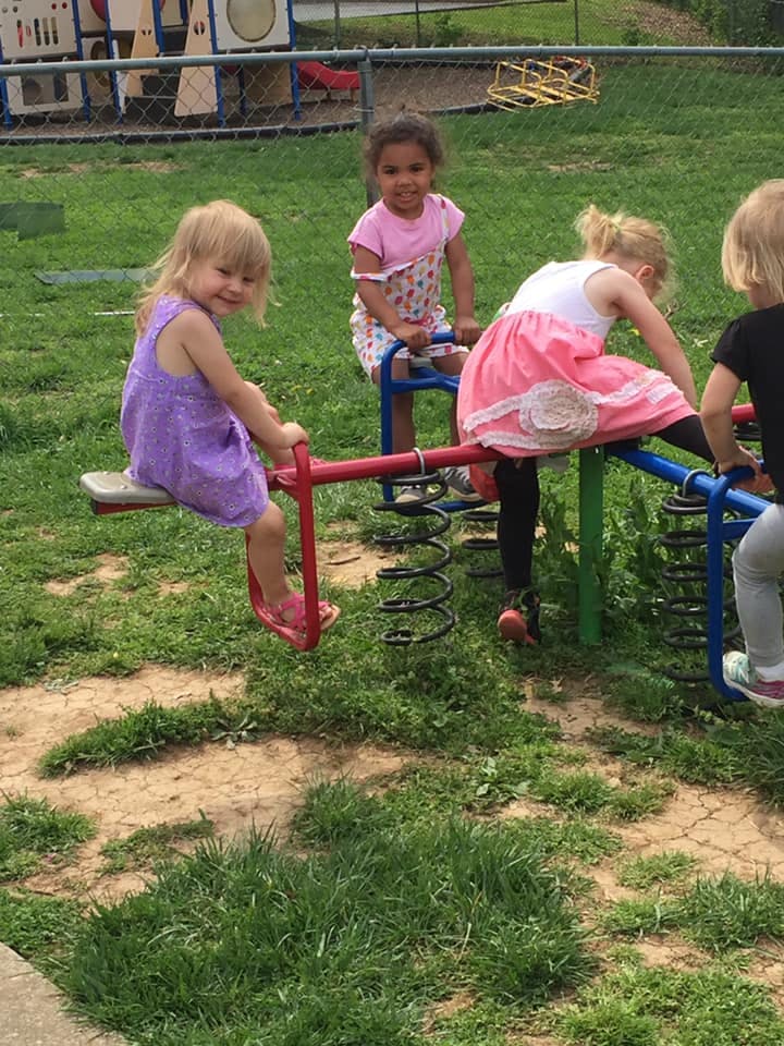 Children playing on a seesaw at a playground