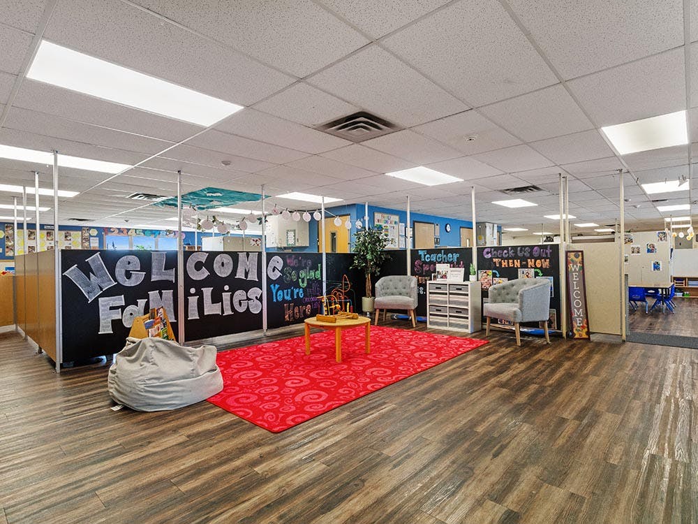Lobby area of a classroom with a welcome sign, beanbag, and seating