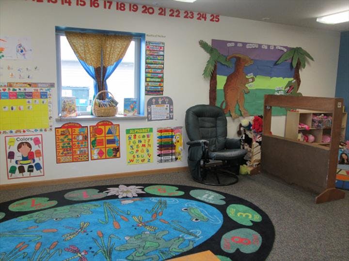 Classroom with a colorful rug, window, and educational posters