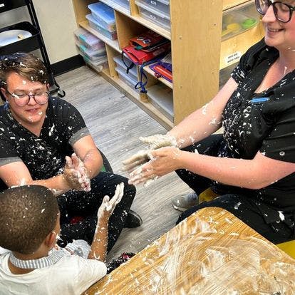 People and a child covered in white powder