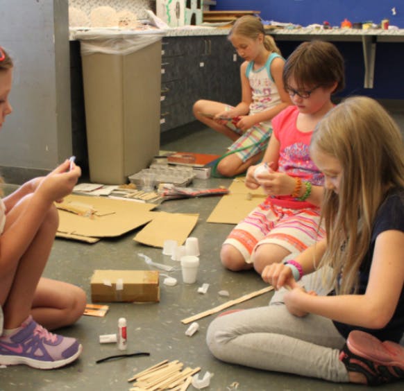 Children sitting on the floor doing crafts