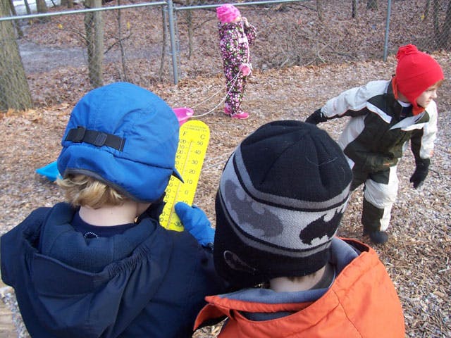 Three children playing outdoors