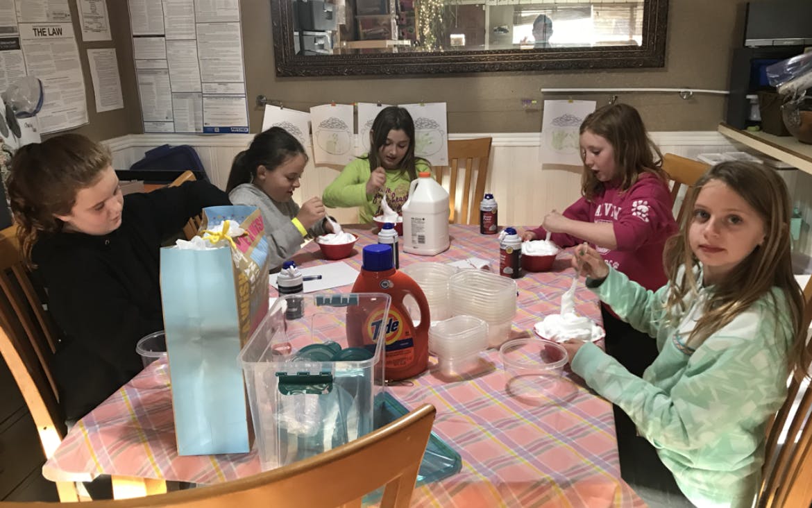 Children sitting around a table making crafts