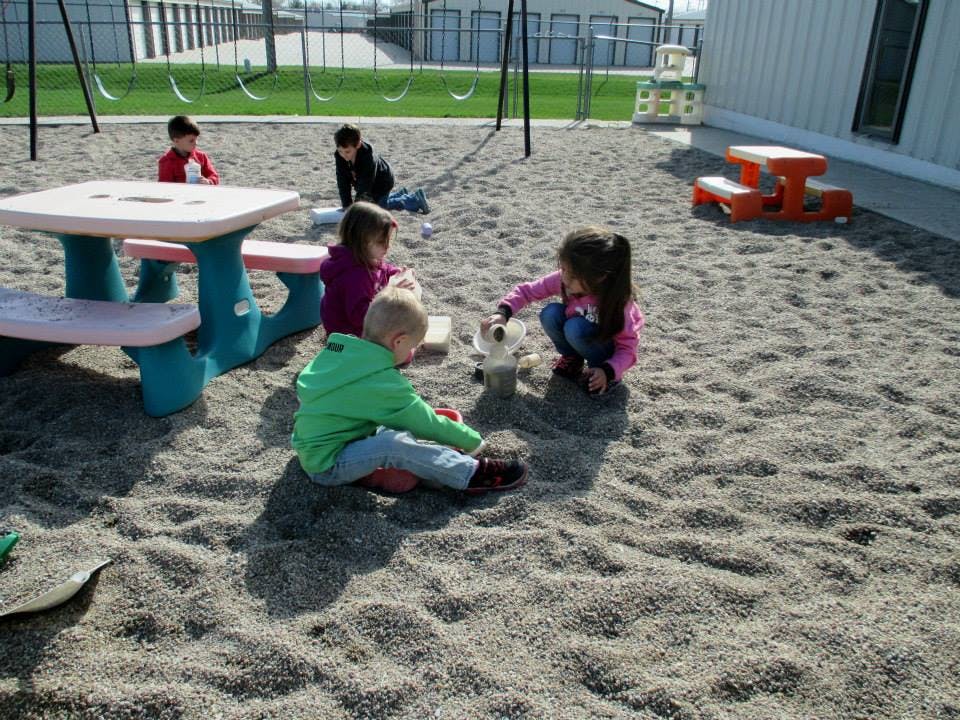 Children playing in sand at a playground