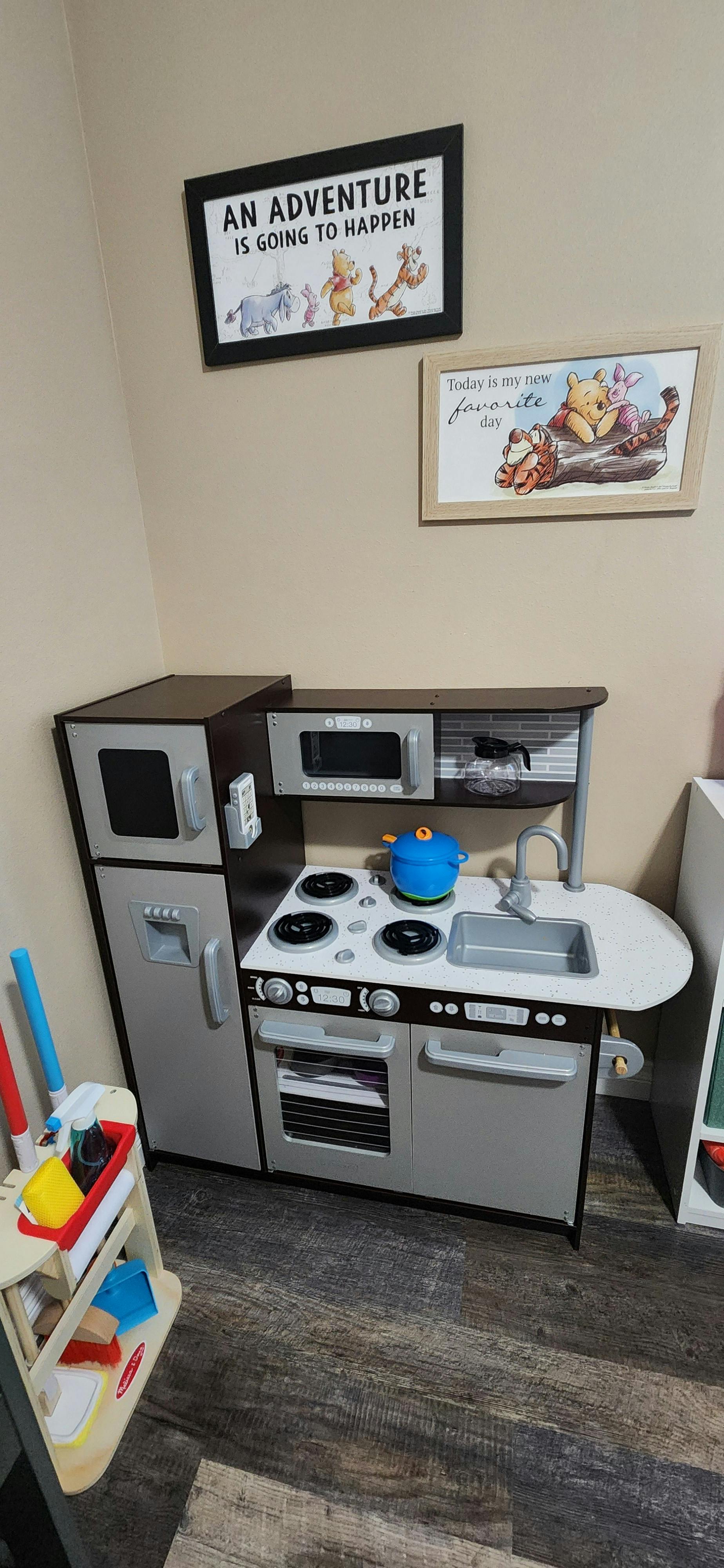 Toy kitchen set with a refrigerator, stove, oven, microwave, and sink