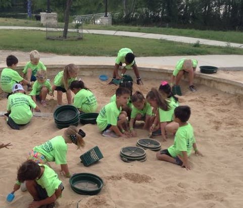 Children playing in a large sandbox