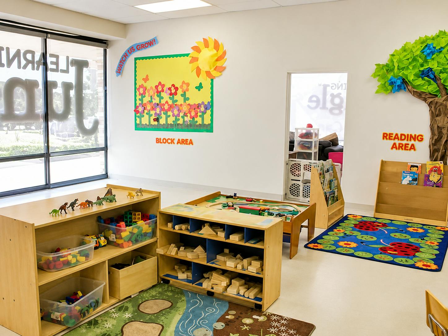 Childcare classroom with block and reading areas featuring shelves and toys