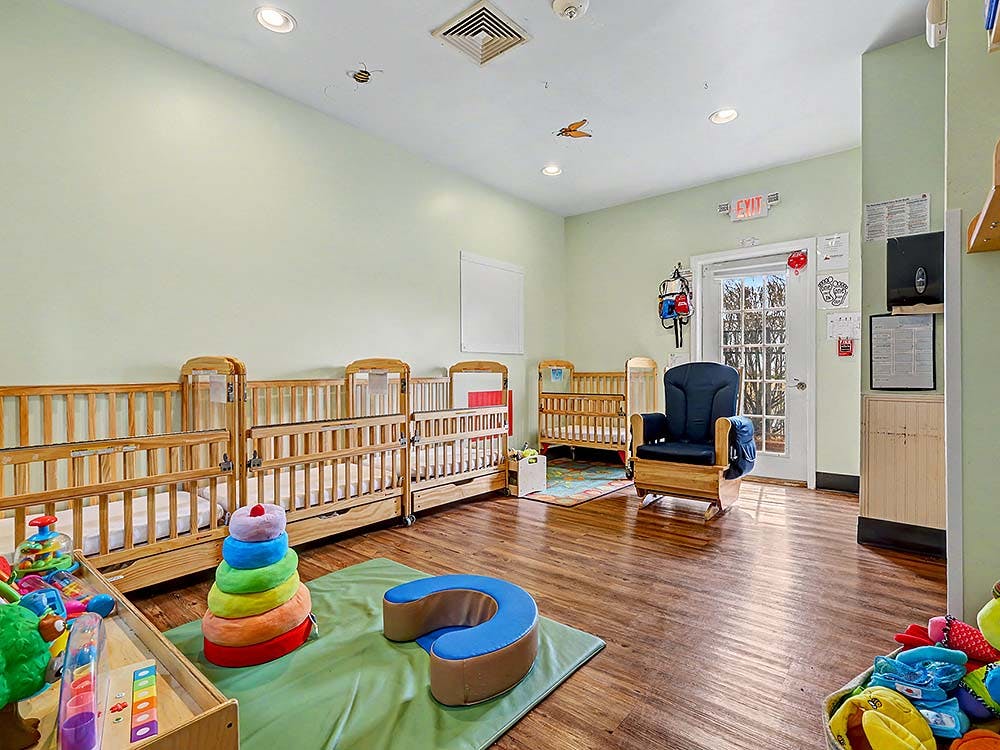 Cribs and toys in a daycare room