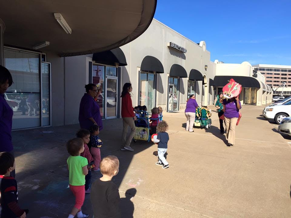 People and children gathered outside a building