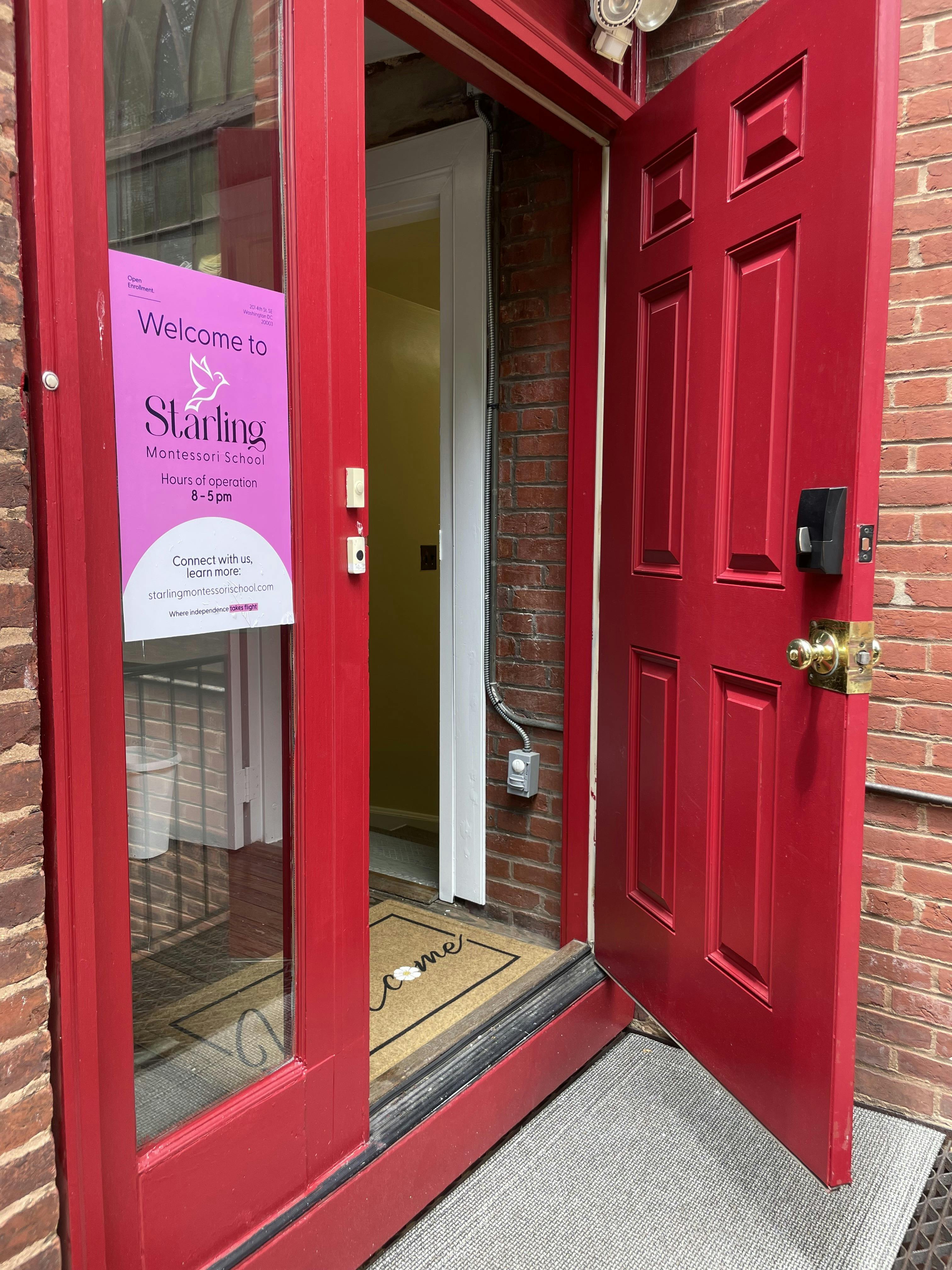 Red door with a pink sign that says "Welcome to Starling"