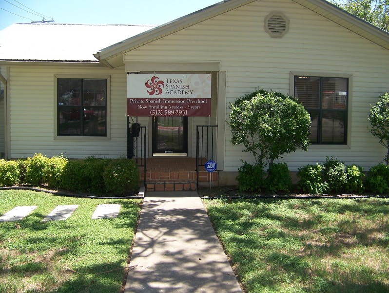 Front of a house with a sign that reads "Texas Spanish Academy"