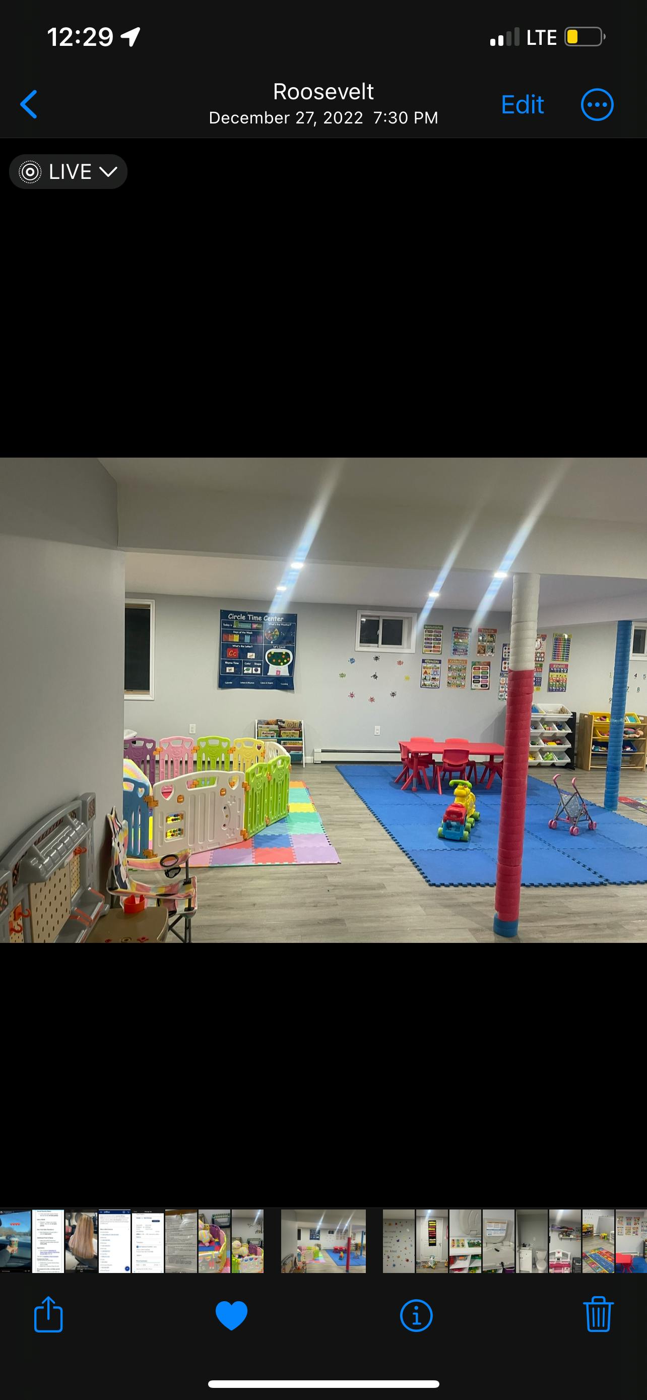 Playroom with colorful mats, playpens, and small red tables